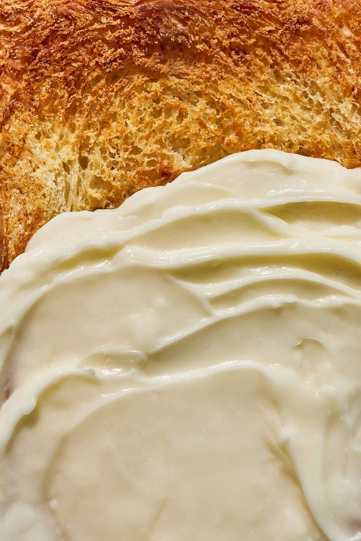 Butter spread next to toasted bread